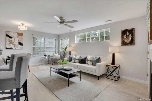 a living room with furniture a rug and a window