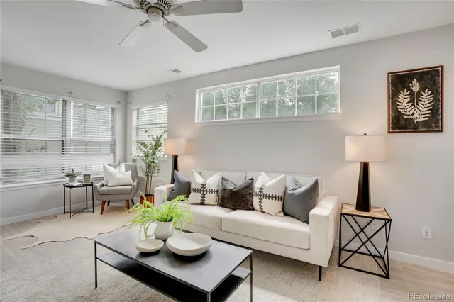a living room with furniture a chandelier and a window