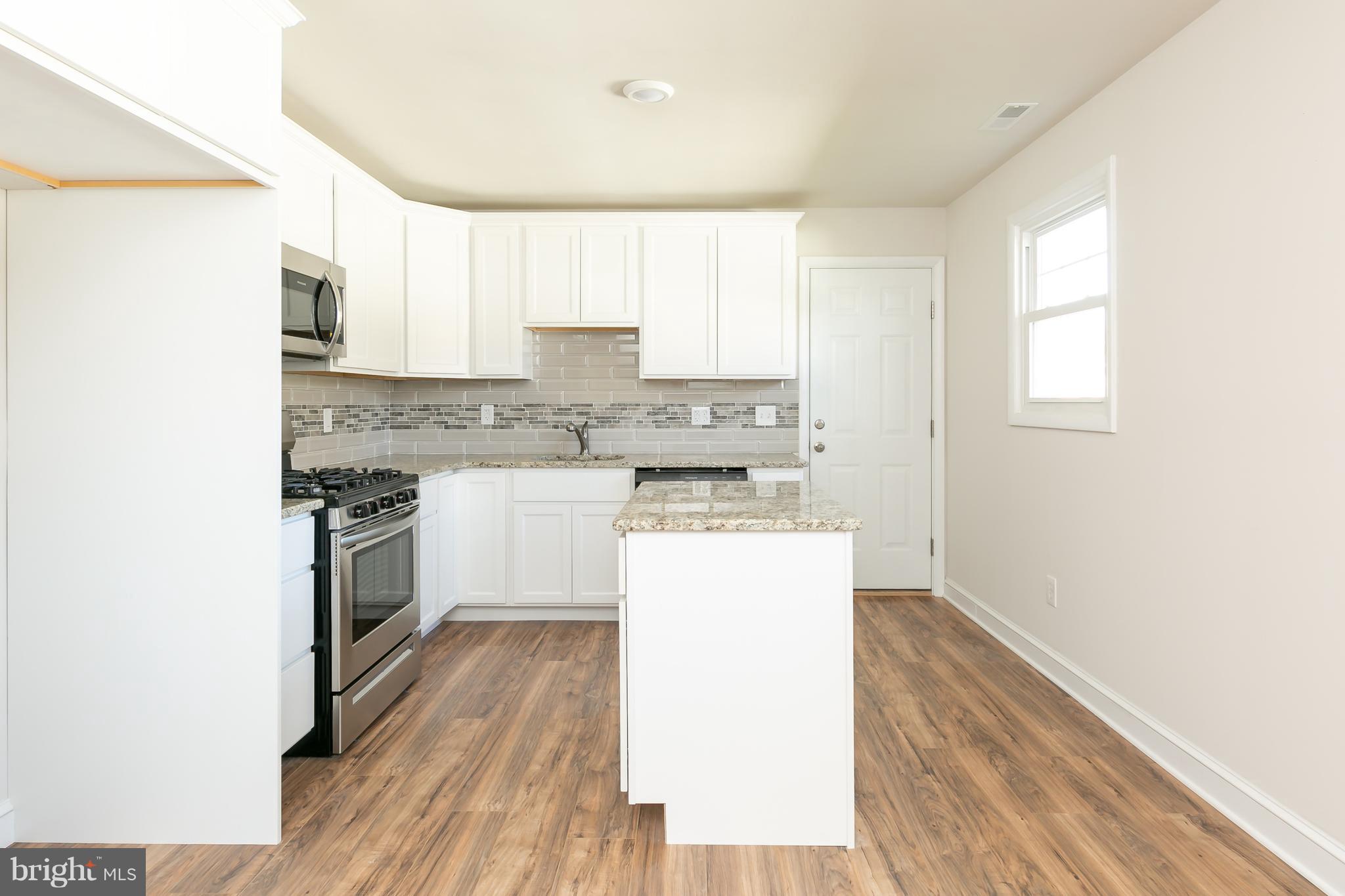 126 Eaton Road Pennsville, NJ 08070 - Photo 11 of 29 a kitchen with a sink cabinets stainless steel appliances and a window