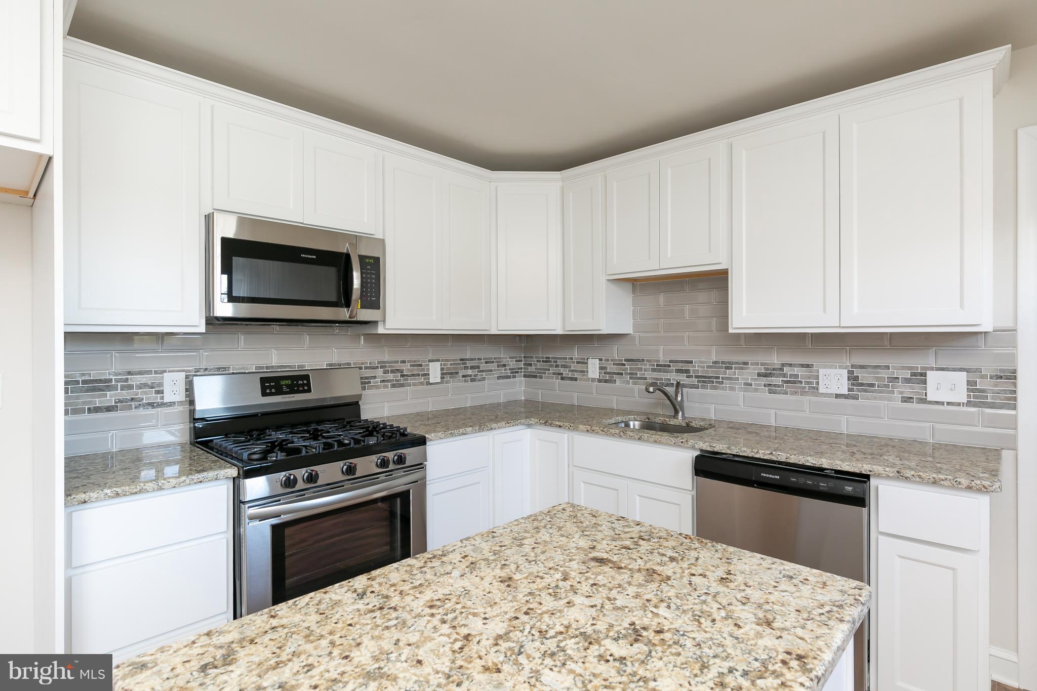 126 Eaton Road Pennsville, NJ 08070 - Photo 14 of 29 a kitchen with granite countertop a stove top oven microwave and cabinets