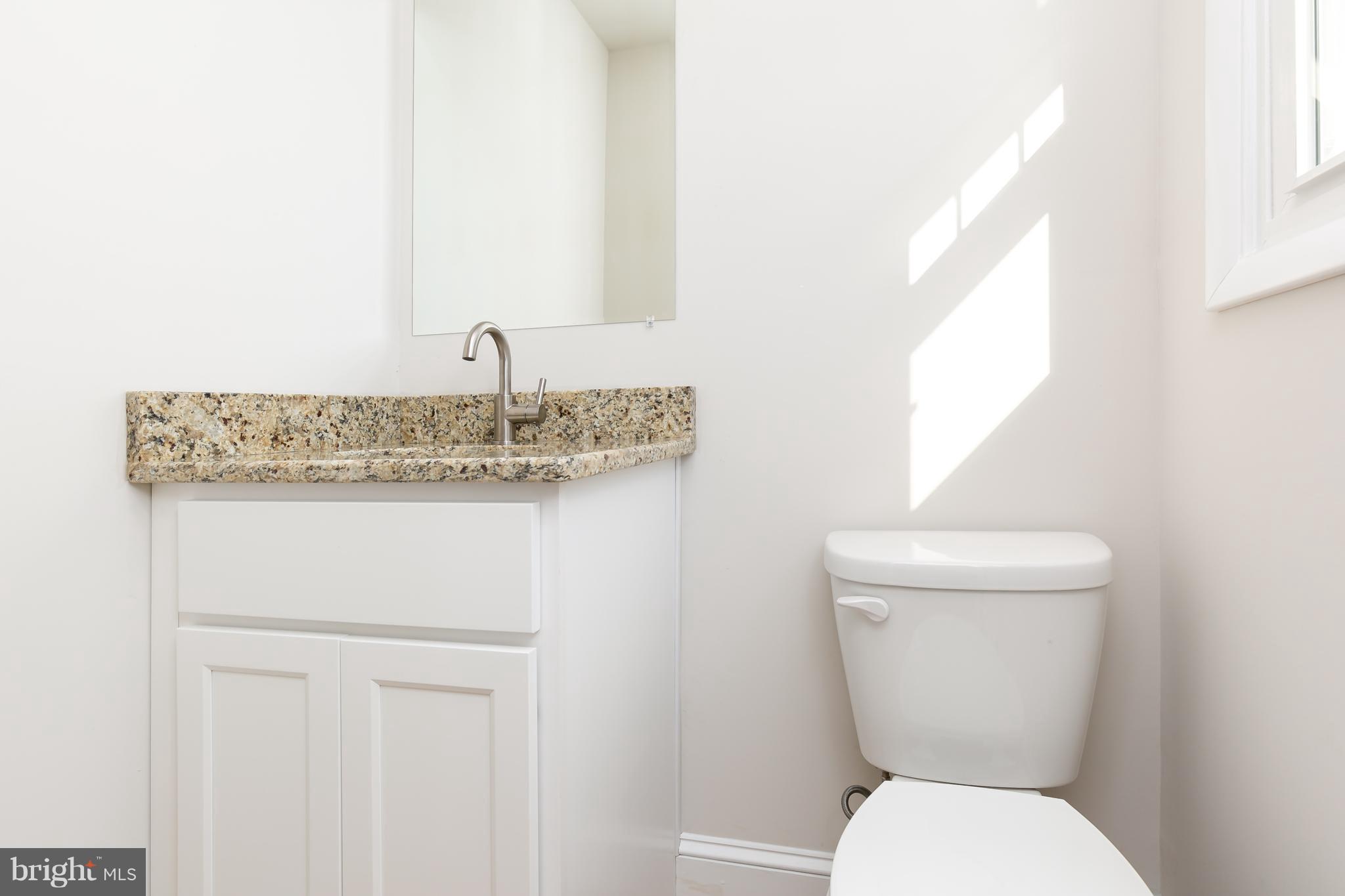 126 Eaton Road Pennsville, NJ 08070 - Photo 20 of 29 a bathroom with a toilet sink and mirror