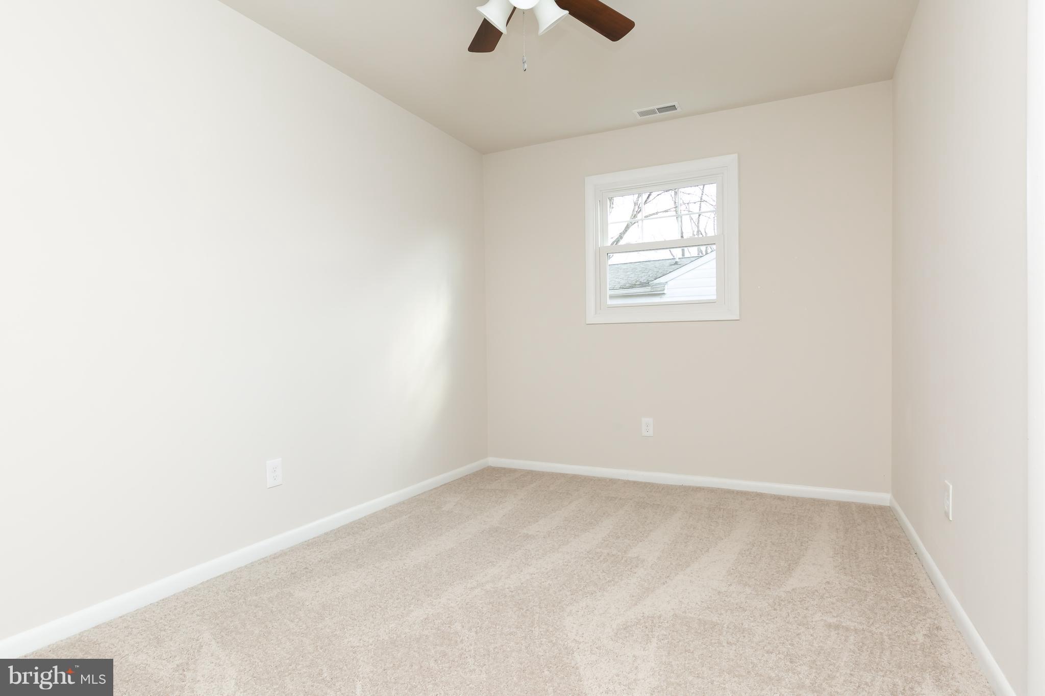 126 Eaton Road Pennsville, NJ 08070 - Photo 21 of 29 an empty room with a window and a ceiling fan