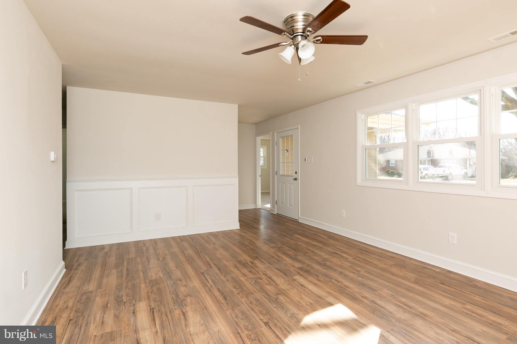 126 Eaton Road Pennsville, NJ 08070 - Photo 9 of 29 a view of empty room with wooden floor and fan