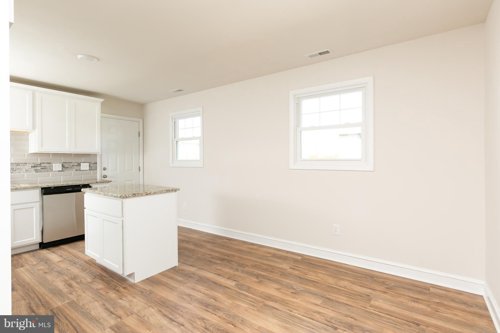 126 Eaton Road Pennsville, NJ 08070 - Photo 10 of 29 a kitchen with granite countertop white cabinets and white appliances