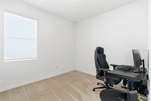 a living room with furniture and a air conditioner vent