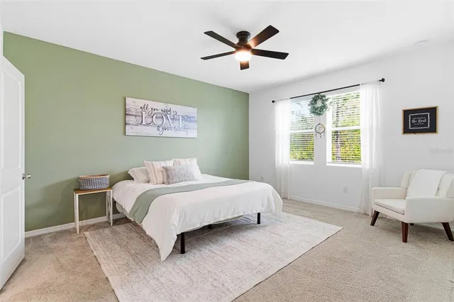 a bedroom with a bed and ceiling fan