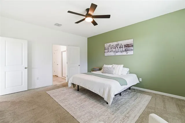 a bathroom with a granite countertop double vanity sink a mirror and