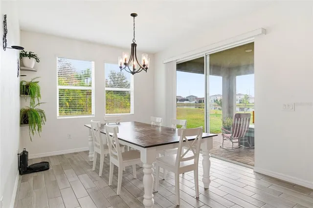 a living room with kitchen island furniture and a chandelier