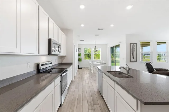 a living room with furniture a flat screen tv and a large window
