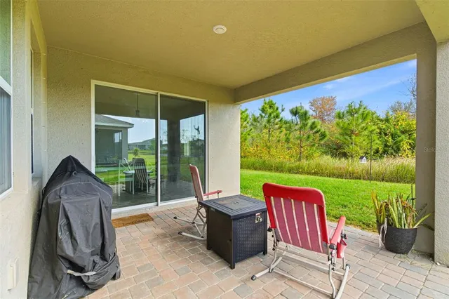 a view of a porch with furniture and a yard