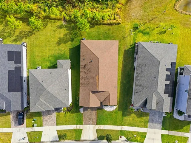 an aerial view of residential houses with outdoor space and swimming pool