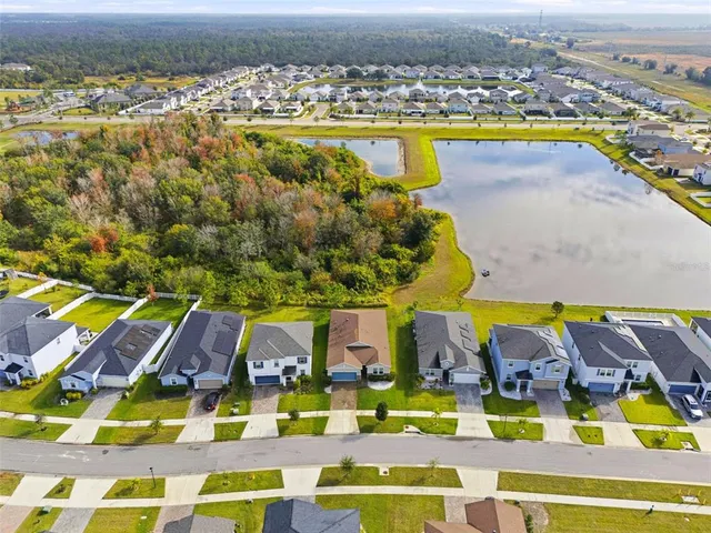 an aerial view of residential houses with outdoor space and swimming pool