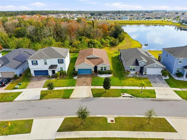 an aerial view of residential houses with outdoor space