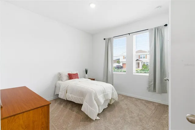 a bedroom with a bed and dresser