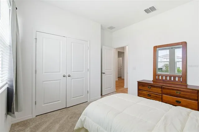 a bathroom with a granite countertop sink a toilet and a mirror