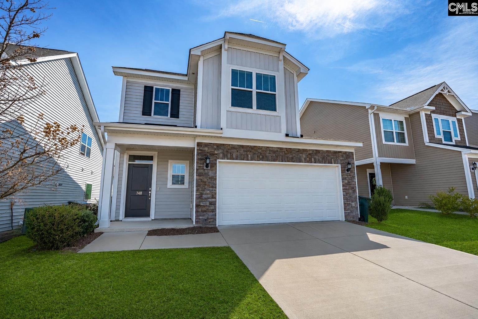 748 North Pinewalk Way Elgin, SC 29045 - Photo 1 of 25 a front view of a house with a yard and garage