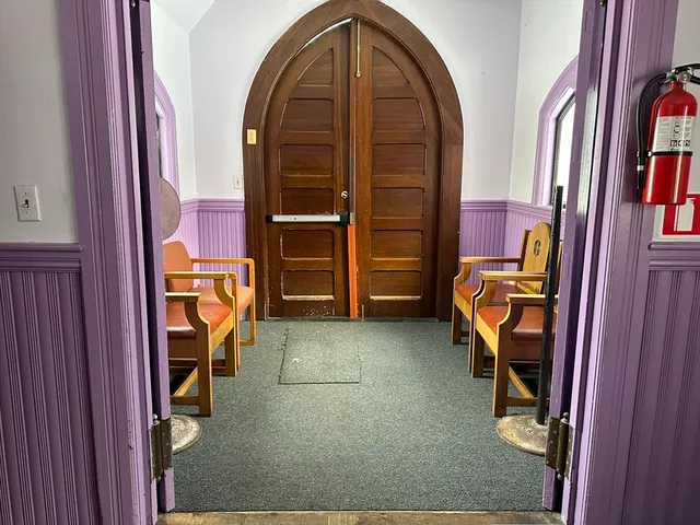 a view of front door with washer and dryer