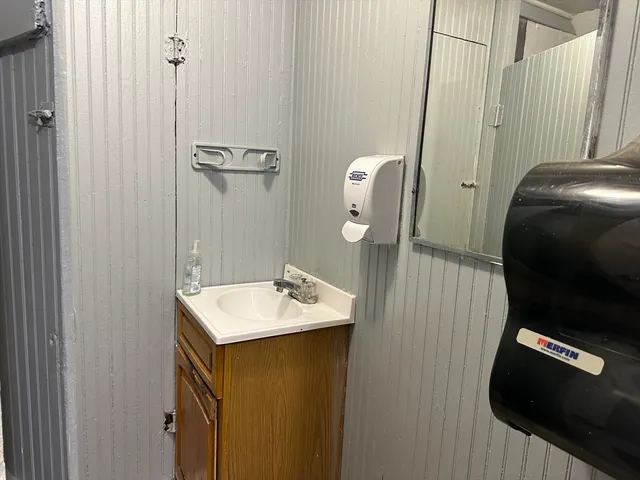 a bathroom with a sink vanity and a mirror