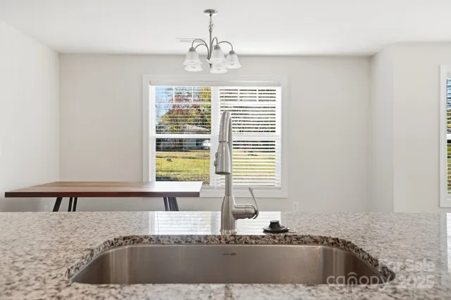 a kitchen with a sink cabinets and window