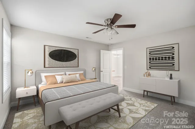 a bedroom with a bed a couch and a window