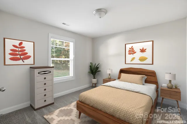 a bedroom with a bed and a painting on the wall