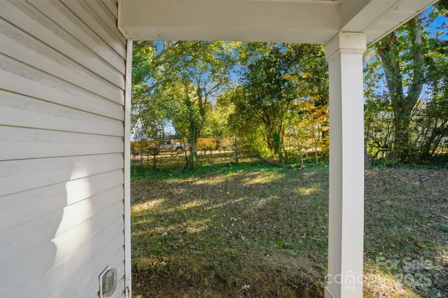 a view of a yard with potted plants
