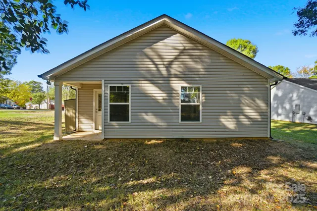 a view of house with backyard