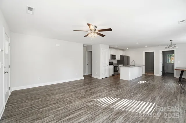a view of a kitchen with a sink and a refrigerator