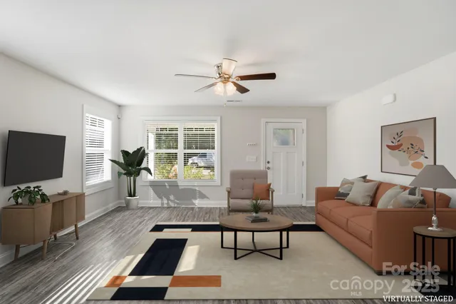 a living room with furniture and a flat screen tv