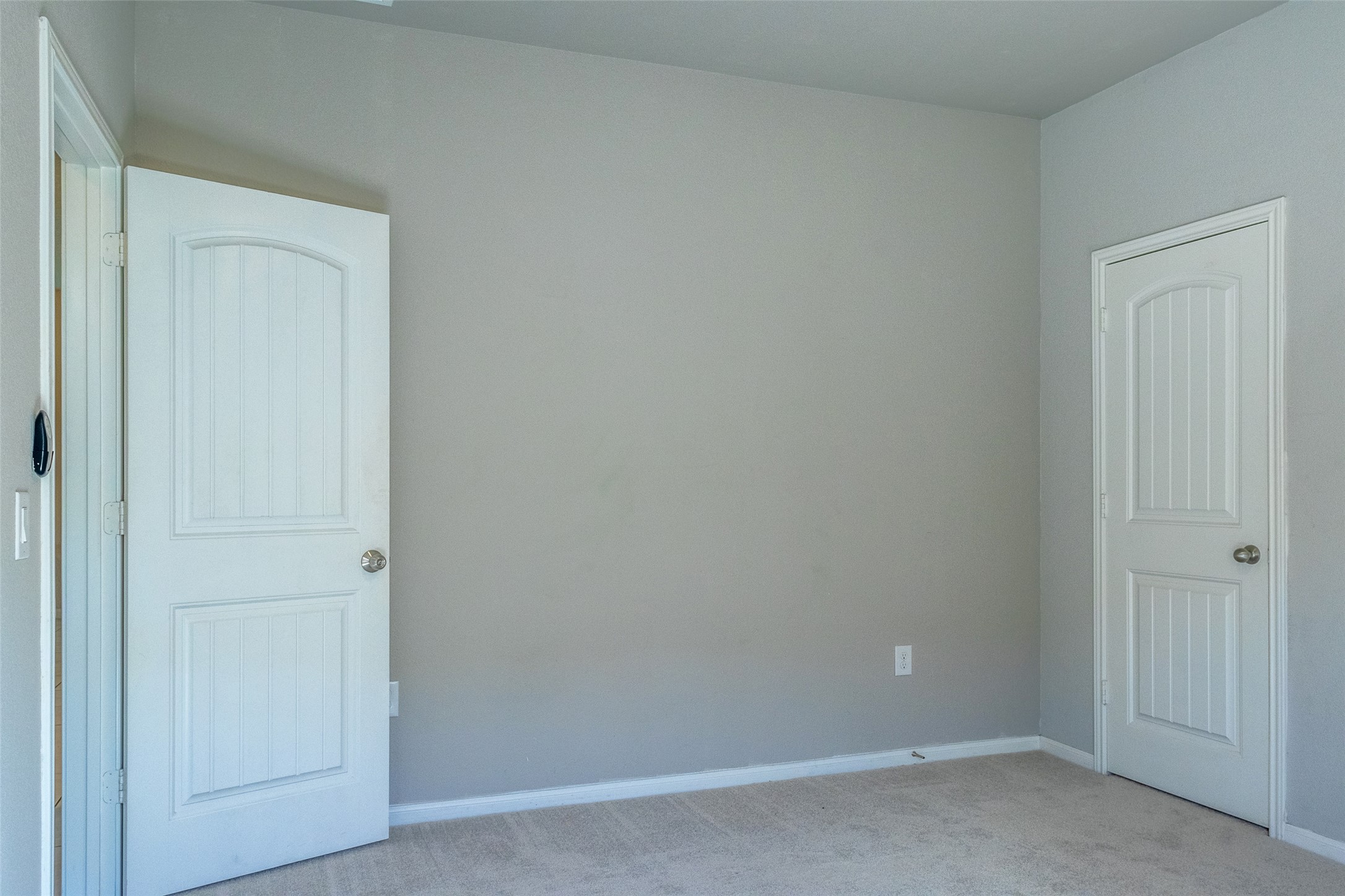 7225 Ranchito Drive Austin, TX 78744 - Photo 16 of 39 An empty room awaits personalization, featuring neutral walls and a carpeted floor, ready for your unique touch.