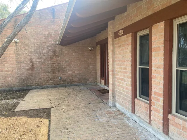 a view of a house with snow on a tree