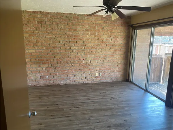a view of a large yard with a large tub and wooden fence