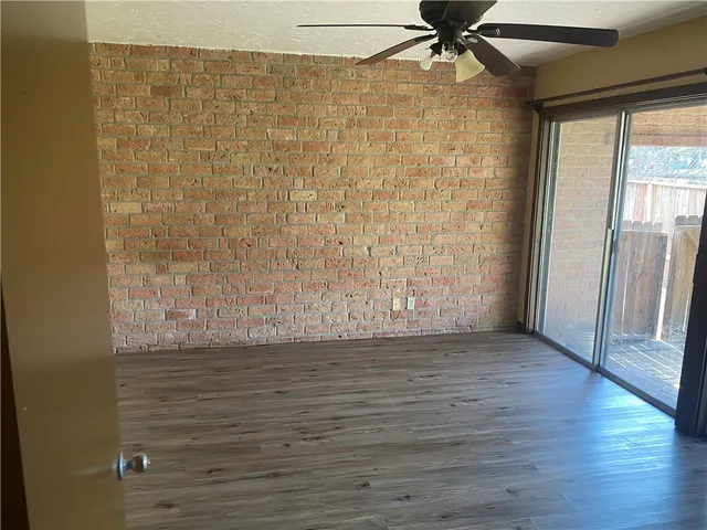 a view of a large yard with a large tub and wooden fence