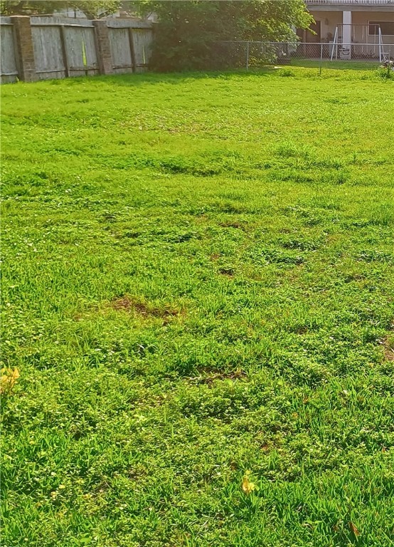 5335 East Riverview Street Robstown, TX 78380 - Photo 17 of 17 a view of a large yard with a large tub and wooden fence