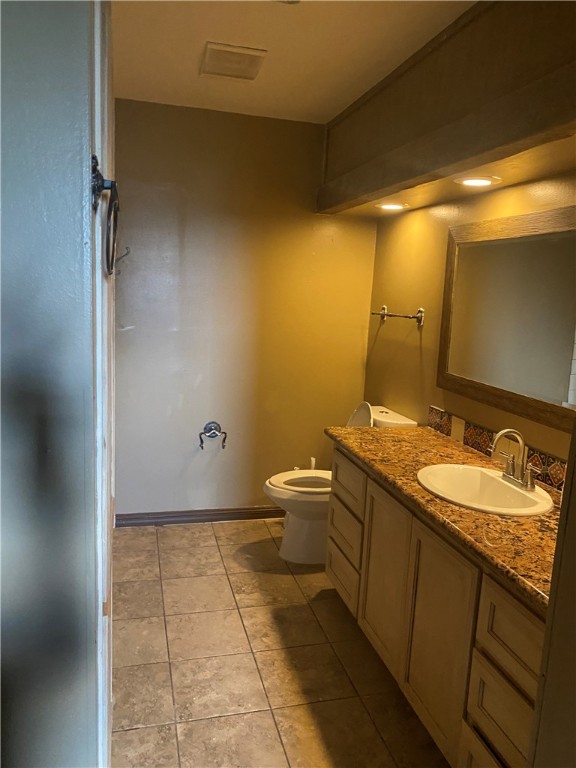 5335 East Riverview Street Robstown, TX 78380 - Photo 9 of 17 a bathroom with a granite countertop sink a toilet and a mirror