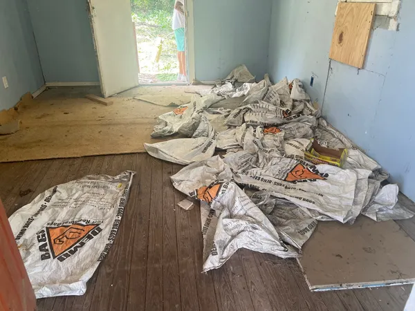 a bed sitting in a bedroom next to a window with yard