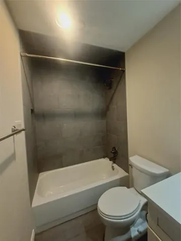 a bathroom with a toilet and a bathtub