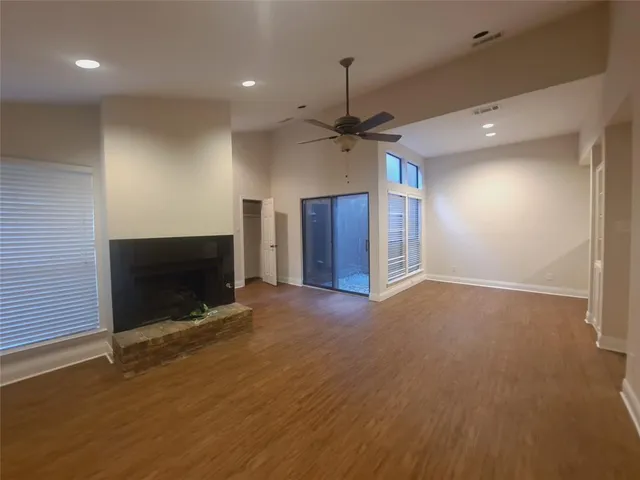 wooden floor in an empty room with a fireplace