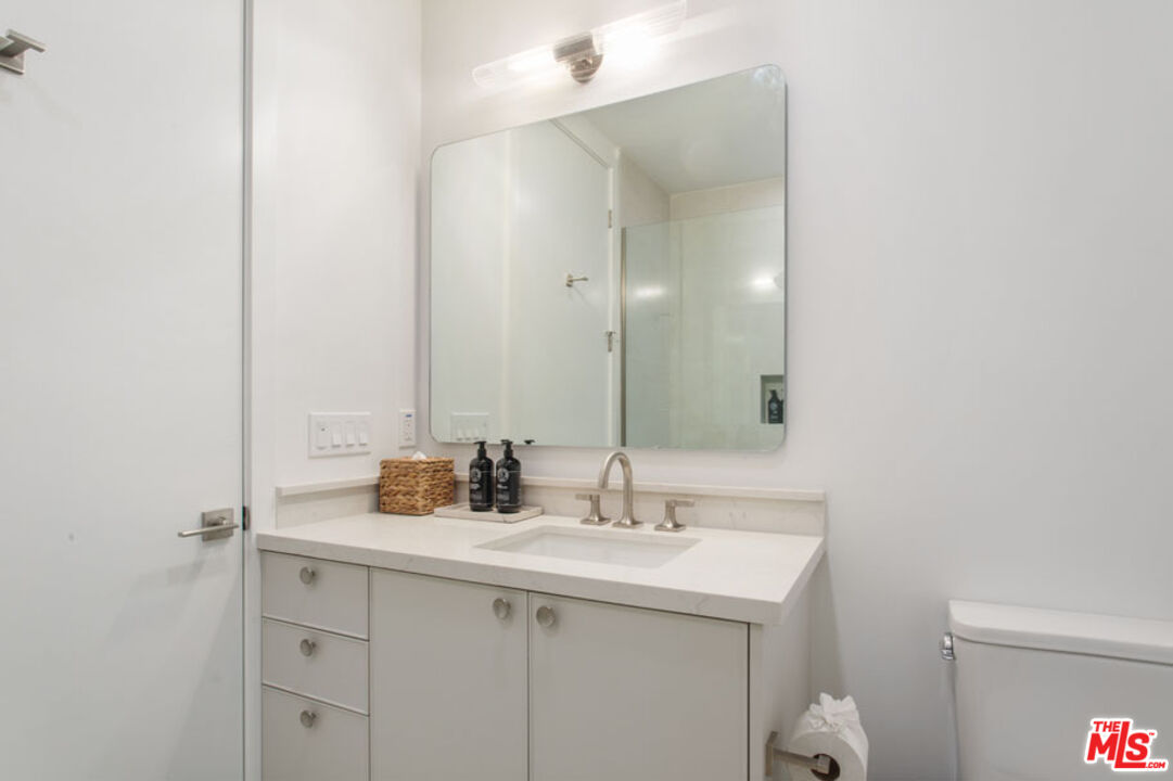 10310 Santa Monica Boulevard, Unit PH710 Los Angeles, CA 90025 - Photo 22 of 38 a bathroom with a sink and a mirror