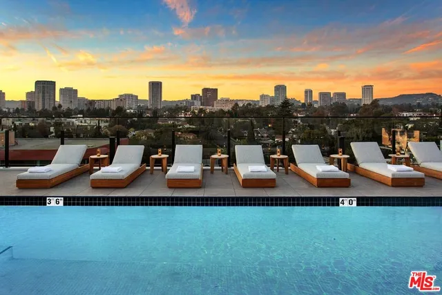 a terrace with outdoor seating and city view