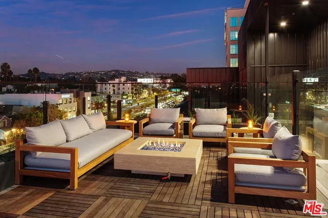 a view of a terrace with seating area and city view