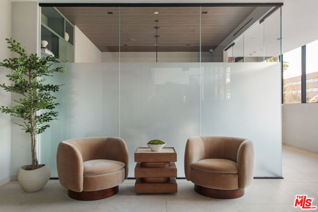 10310 Santa Monica Boulevard, Unit PH710 Los Angeles, CA 90025 - Photo 34 of 38 a backyard of a house with furniture and a potted plant