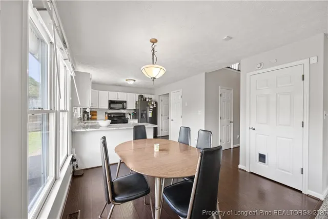 a view of a dining room with furniture wooden floor and a chandelier