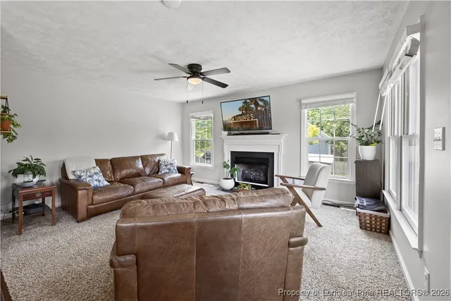 a bedroom with a bed a couch and a window