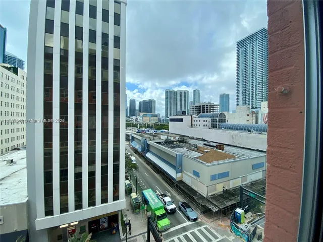 a view of a balcony with chairs and stove