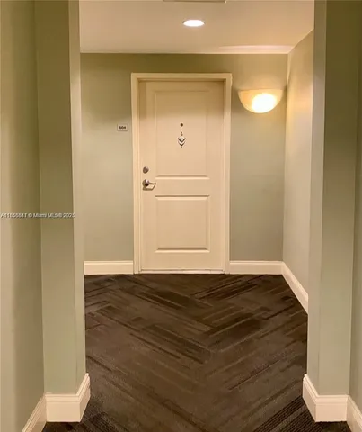 a view of a room with wooden floor and cabinet