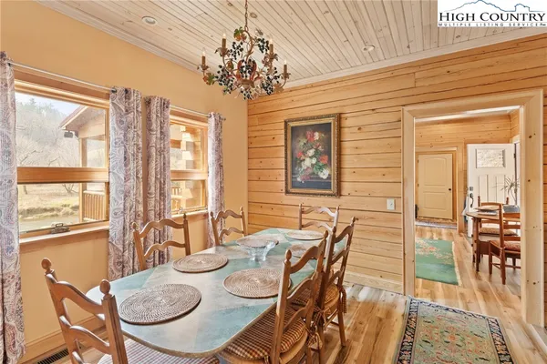 a view of a dining room with furniture wooden floor and chandelier