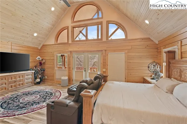 a bedroom with a bed and a flat screen tv