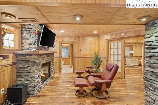 a living room with fireplace furniture and a flat screen tv
