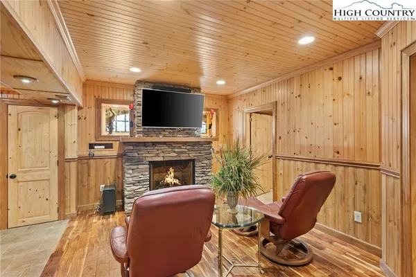 a living room with furniture a fireplace and a flat screen tv